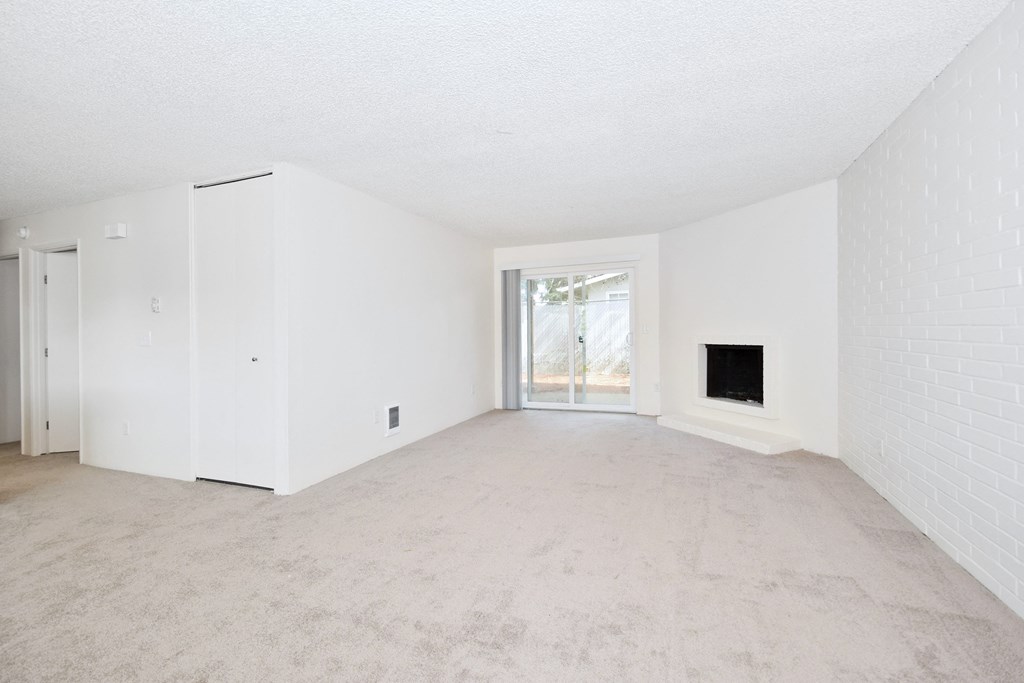 Menlo Manor: living room with a fireplace and a sliding glass door