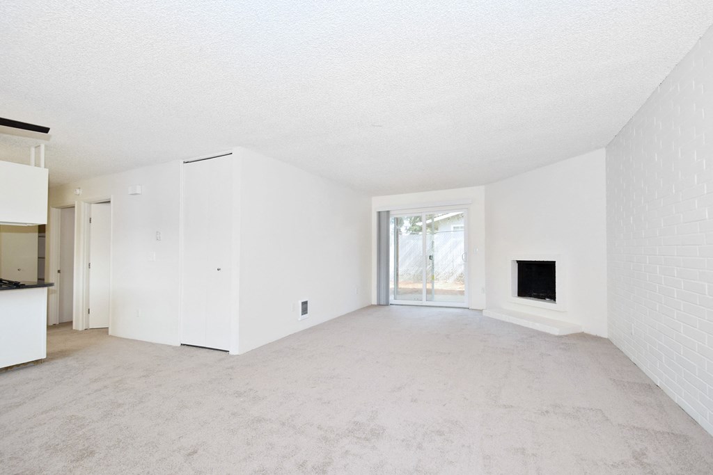 Menlo Manor:  living room with a fireplace and a kitchen in the background