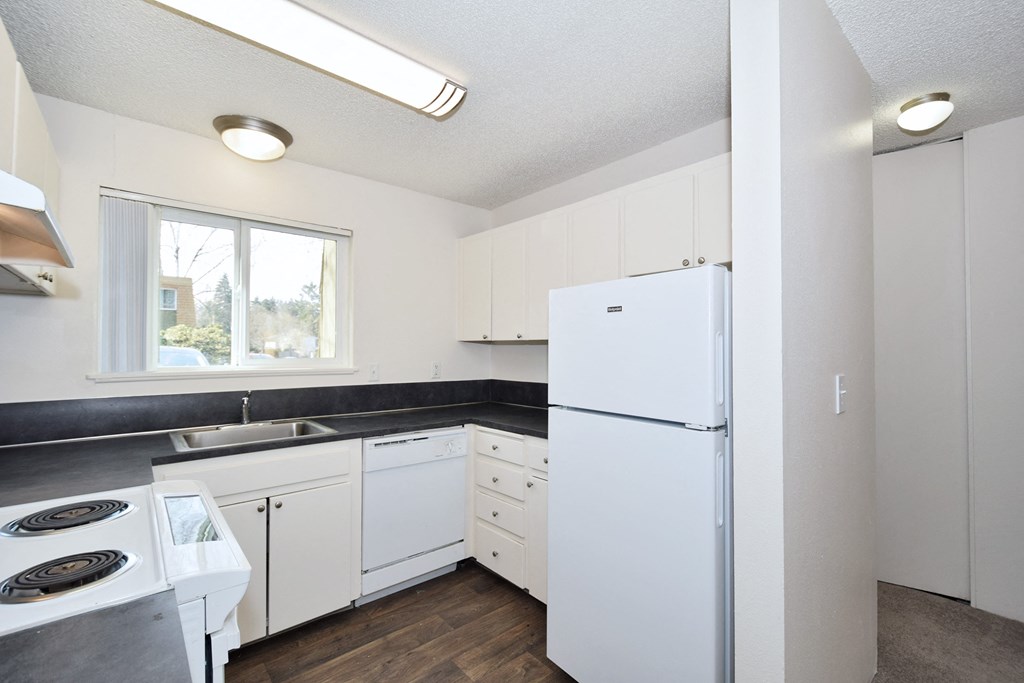 Menlo Manor: kitchen with white appliances and white cabinets