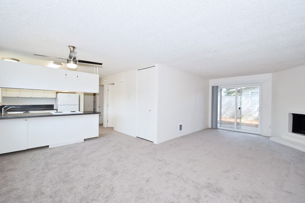 Menlo Manor: living room and kitchen with a sliding glass door to a patio