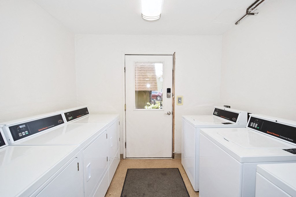Menlo Manor: laundry room with white washers and dryers