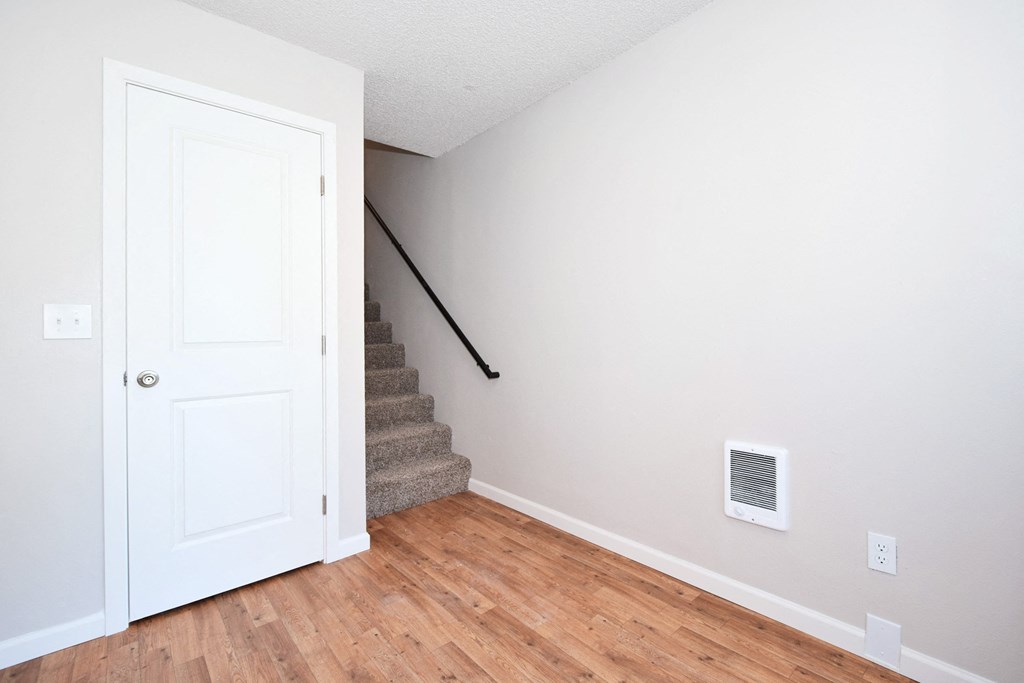 a bedroom with a white door and a stairs with a rail