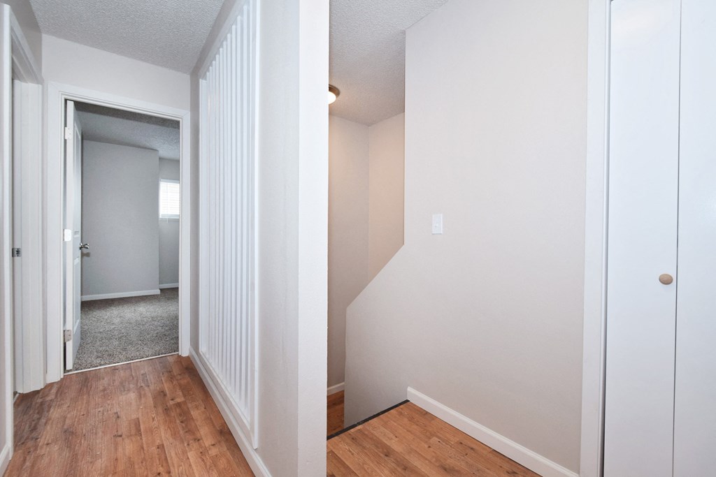 20th and Brooklyn  a bedroom with white walls and wood flooring