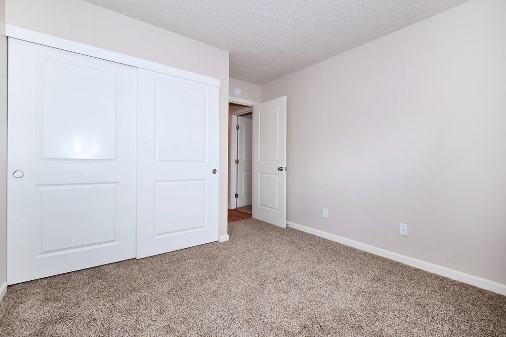 20th and Brooklyn  a bedroom with two doors and a carpeted floor