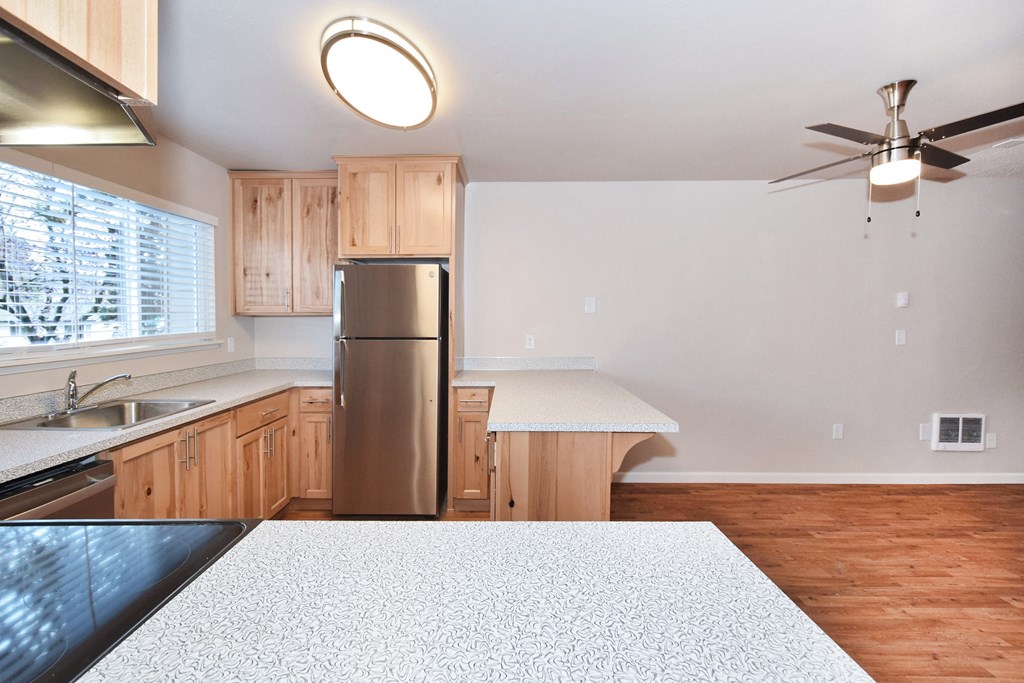 20th and Brooklyn  a kitchen with wood cabinets and white countertops
