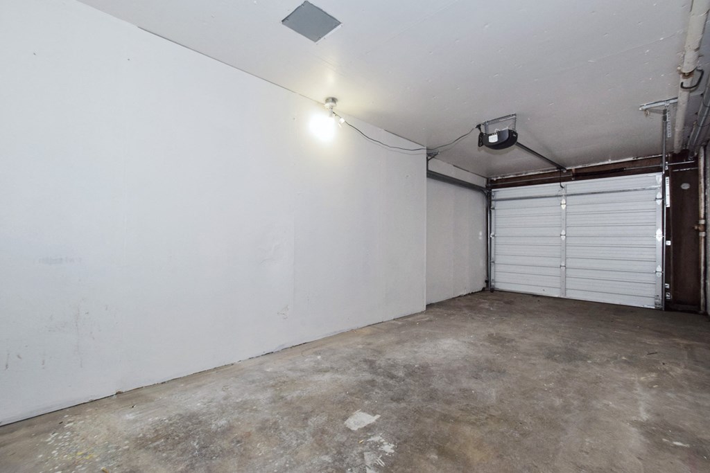 20th and Brooklyn garage the inside of a garage with a white wall and two garage doors
