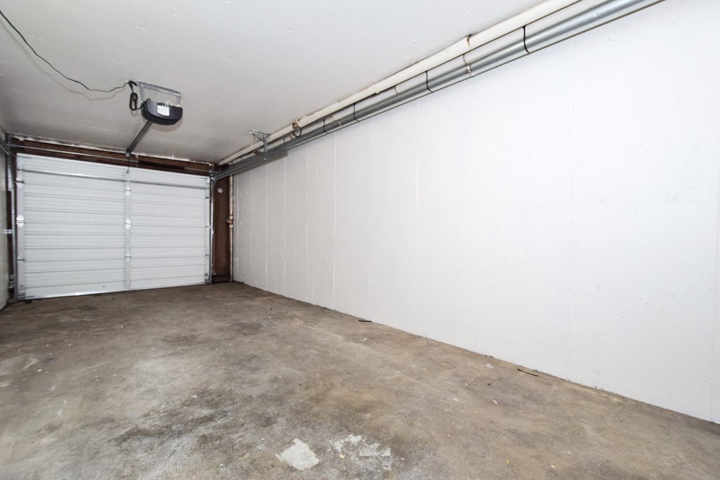 20th and Brooklyn  the interior of a garage with a white wall and two garage doors