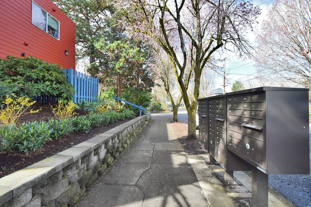 20th and Brooklyn  a mailbox on a sidewalk in front of a red building
