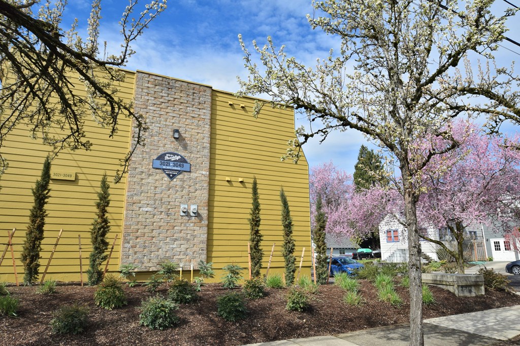 20th and Brooklyn  a yellow building with a blue and white sign on it