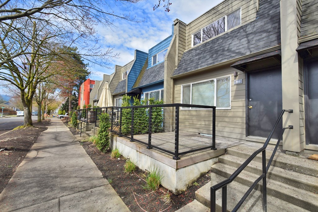 20th and Brooklyn  a row of houses with a sidewalk in front of them