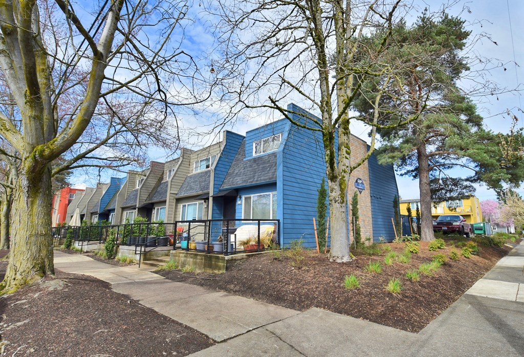 20th and Brooklyn  a row of blue houses with trees in front of them