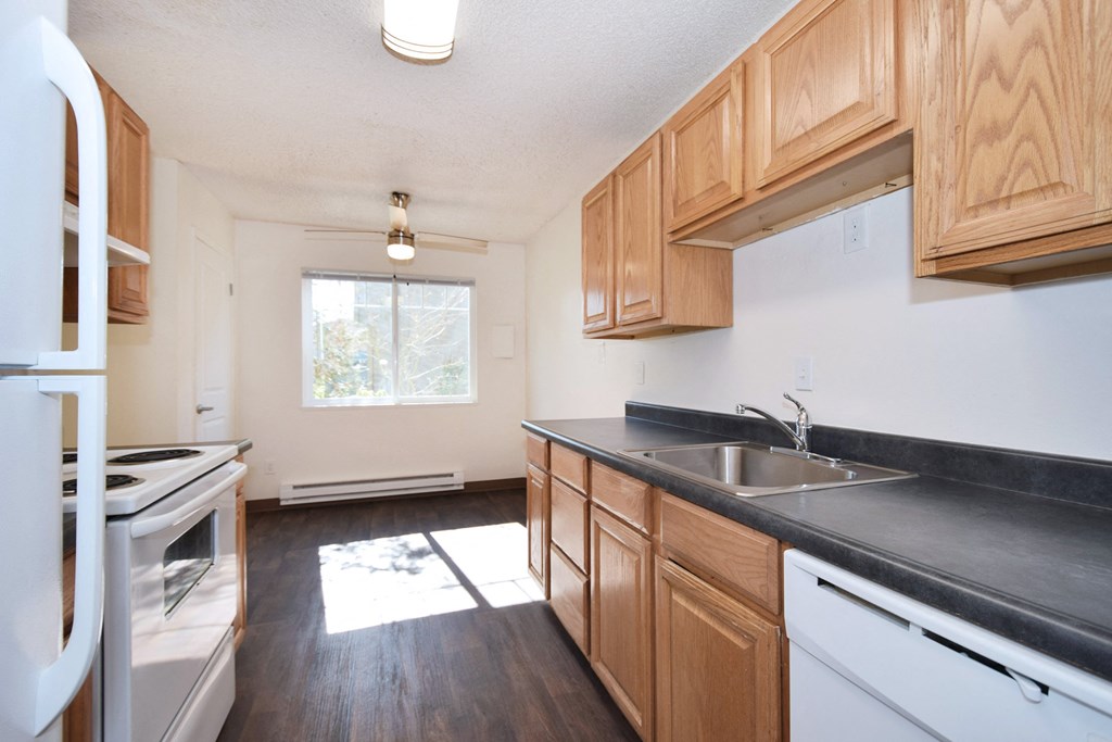 Crescent Ridge kitchen with wood cabinets and white appliances