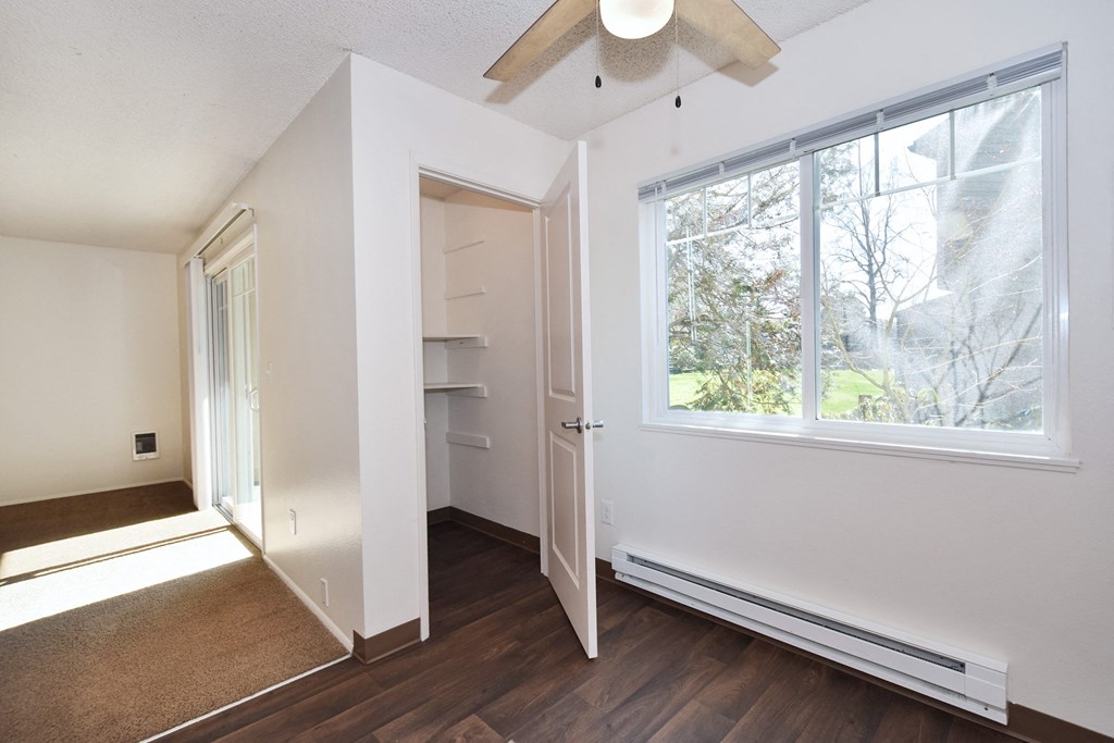 Crescent Ridge bedroom with a large window and a ceiling fan