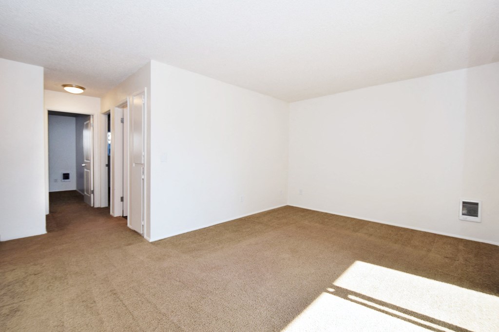 Crescent Ridge living room with white walls and carpet