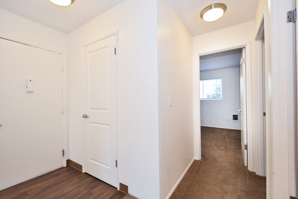 Crescent Ridge bedroom with white walls and a door that leads to a hallway