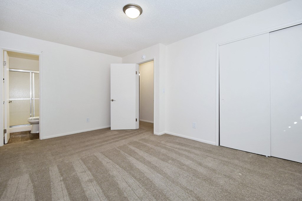 a bedroom with a carpeted floor and white walls