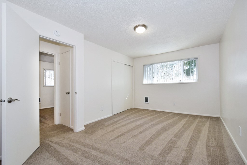 an empty living room with a large window