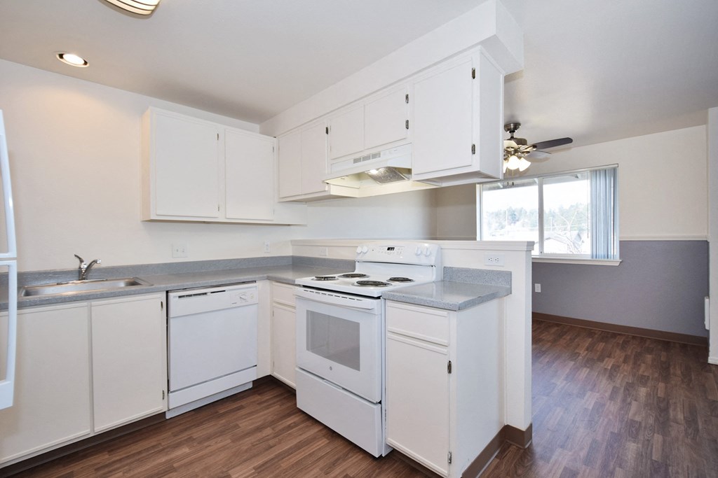 a kitchen with white cabinets and white appliances