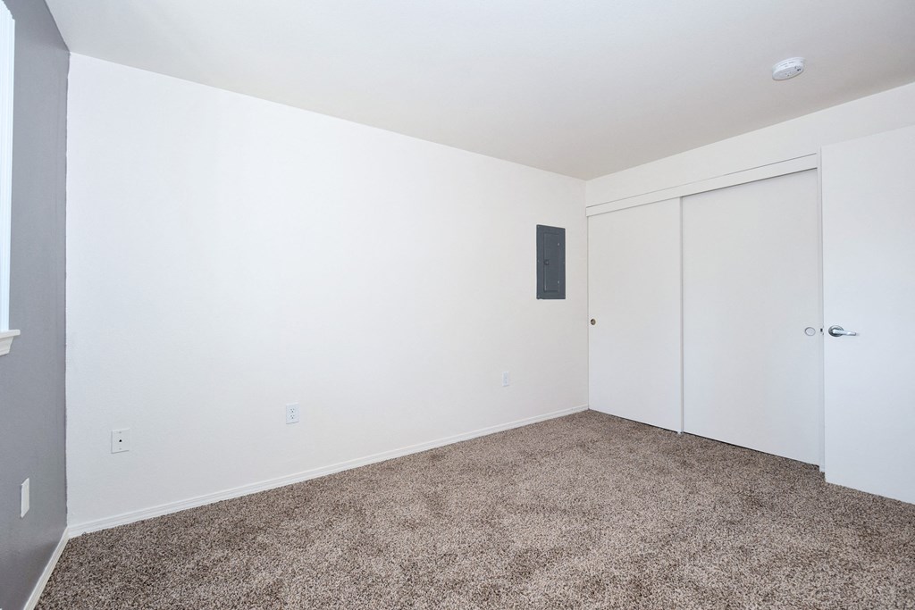 a bedroom with a carpeted floor and white walls