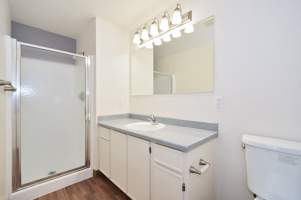 a bathroom with a toilet sink and shower