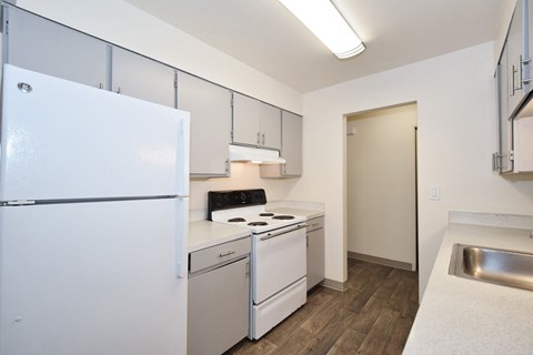 the preserve at ballantyne commons apartment kitchen with white appliances and white cabinets