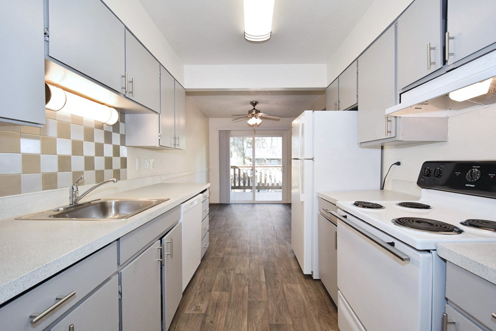 Birnam West: kitchen with white cabinets and white appliances