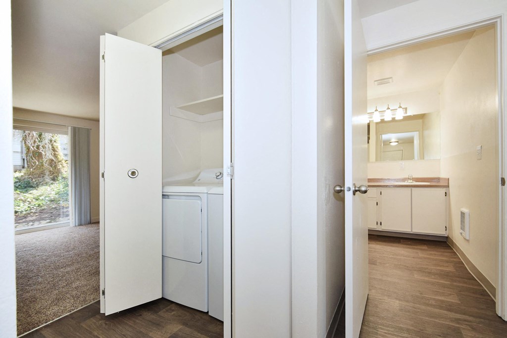 a living room with a washer and dryer