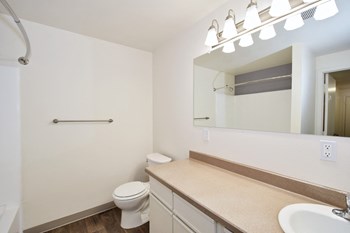 a bathroom with a toilet sink and mirror - Photo Gallery 61