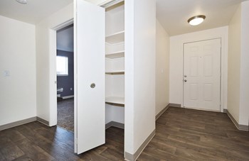 a bedroom with a medium hardwood floor and white walls - Photo Gallery 59