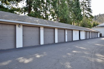 a row of three car garages in a row with trees in the background - Photo Gallery 51