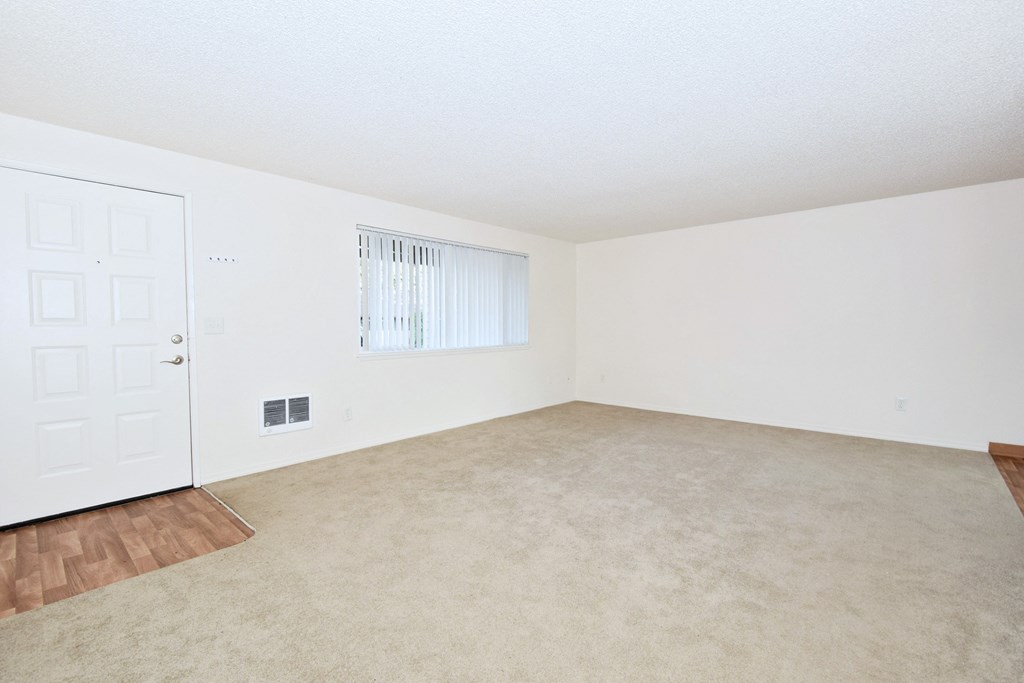 The Firs: living room with hardwood floors and white walls