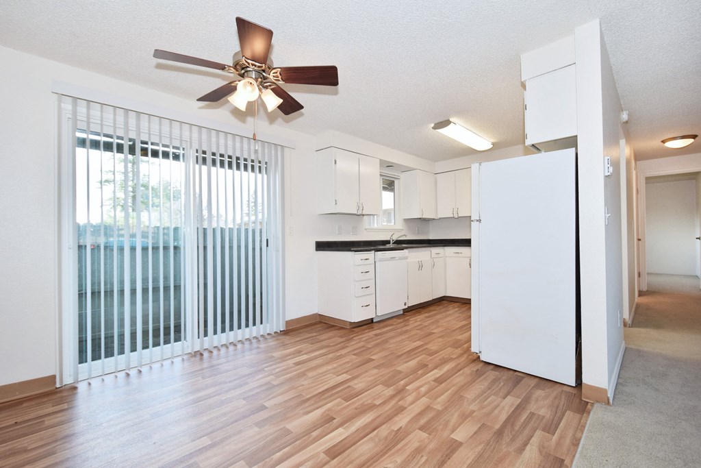 The Firs: living room with a large window and a ceiling fan