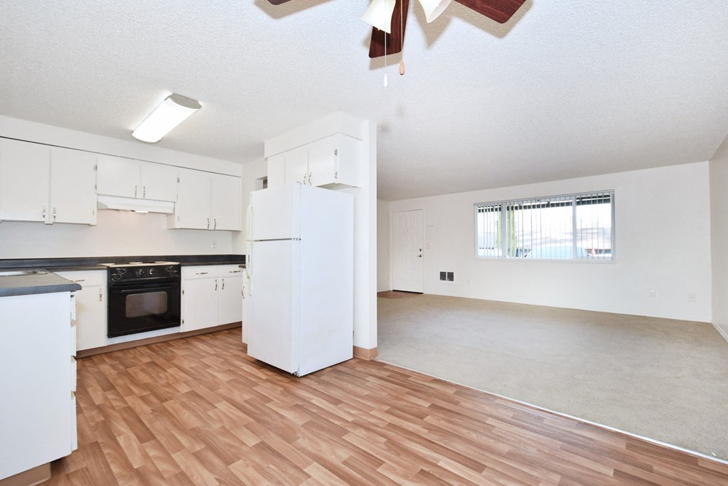 The Firs:  a kitchen and living room with hardwood floors and a ceiling fan