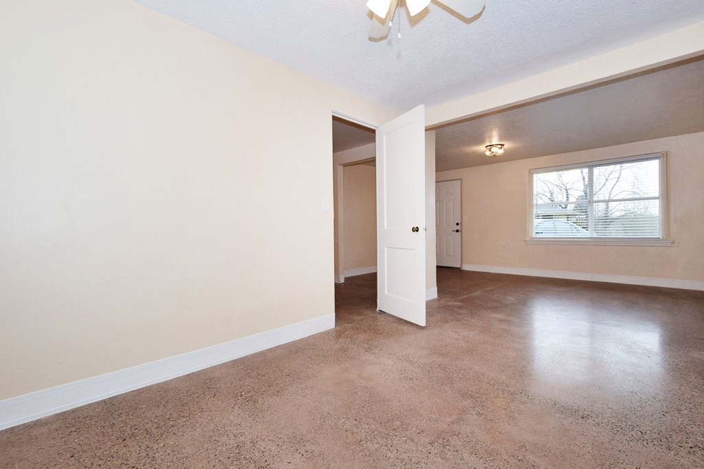 the spacious living room and dining room in a renovated home