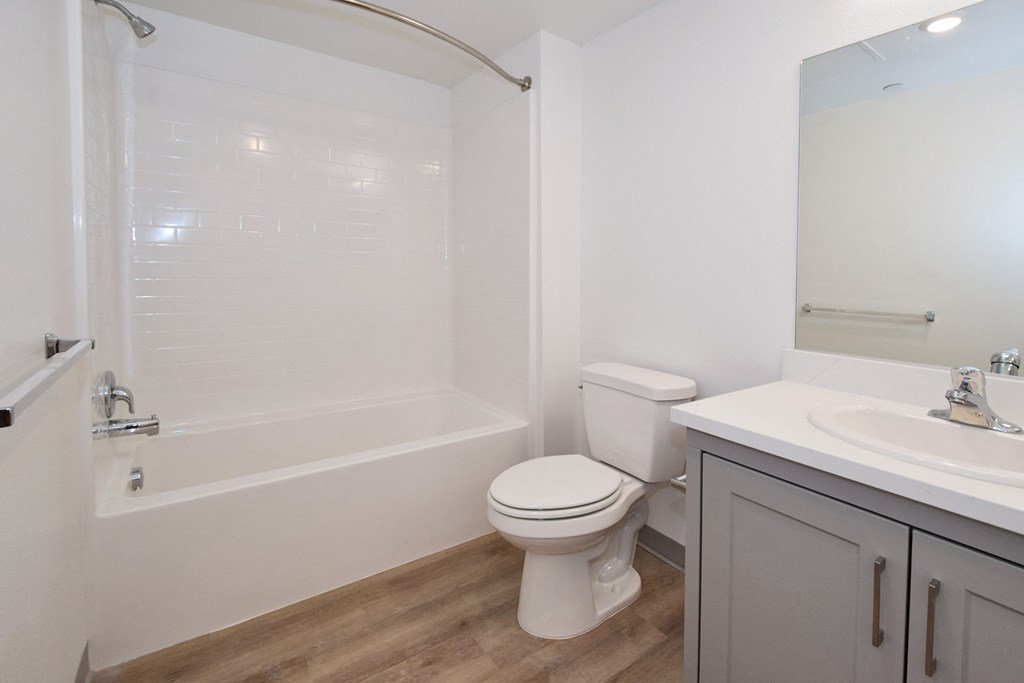 a bathroom with a bathtub toilet and sink in a 555 waverly unit