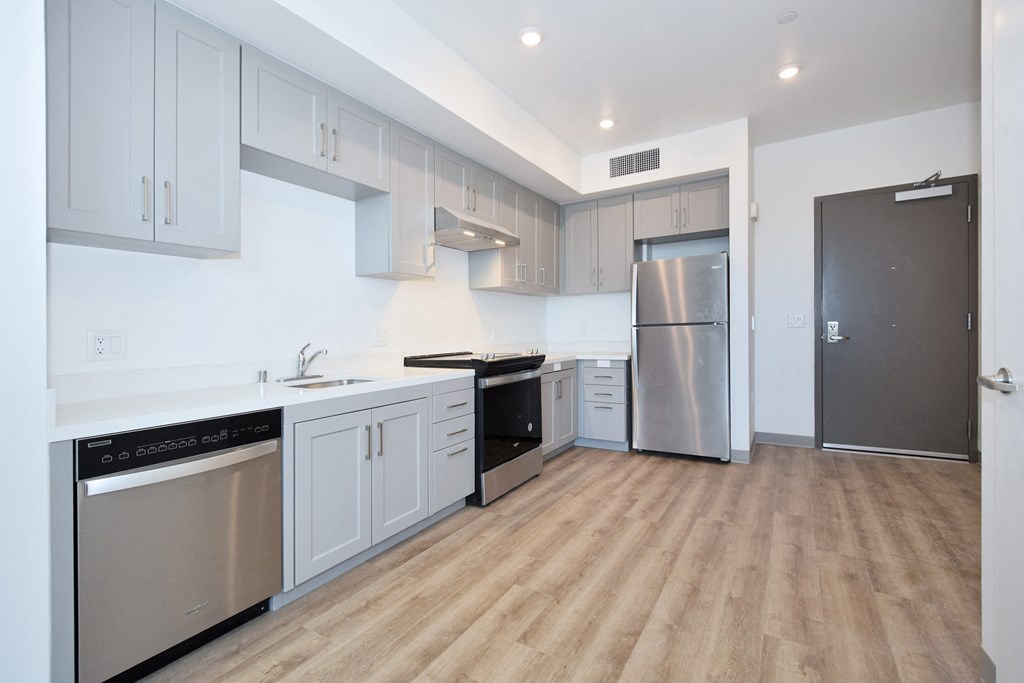 a kitchen with white cabinets and stainless steel appliances