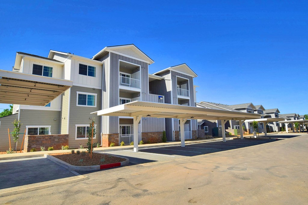 a row of apartment buildings with a blue sky in the background