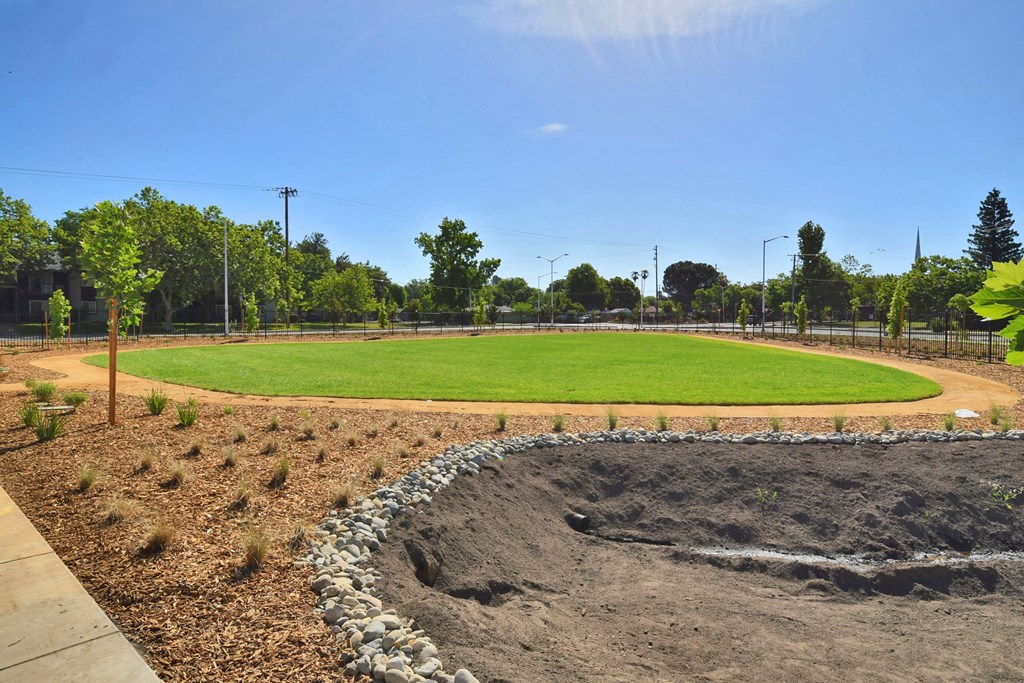 a baseball field with a green field in the middle of it