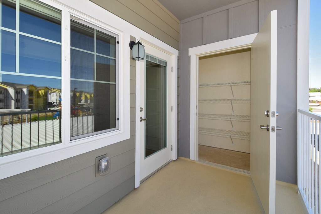 a front porch with a door and windows