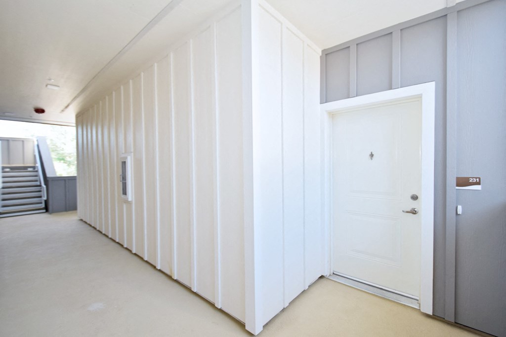 a room with a white wall and a white door