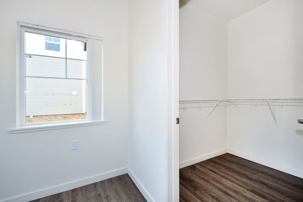an empty room with white walls and a window