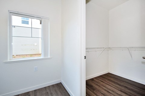 an empty room with white walls and a window