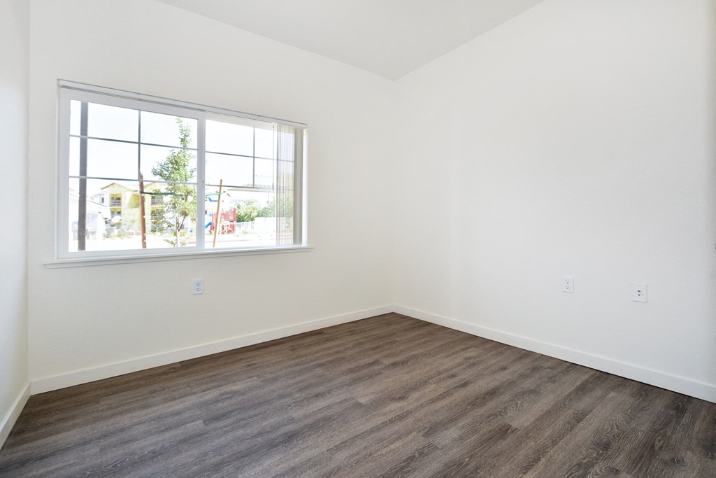 an empty room with white walls and a window
