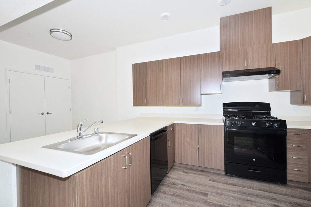 a kitchen with white countertops and wooden cabinets