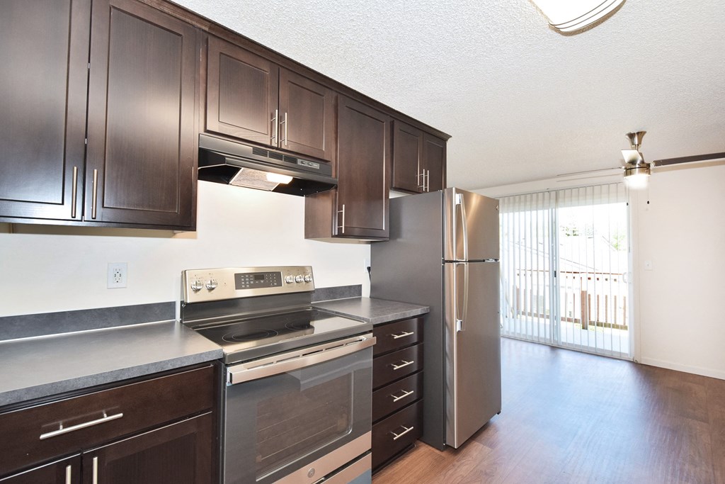 a kitchen at the enclave at woodbridge apartments in sugar land, tx