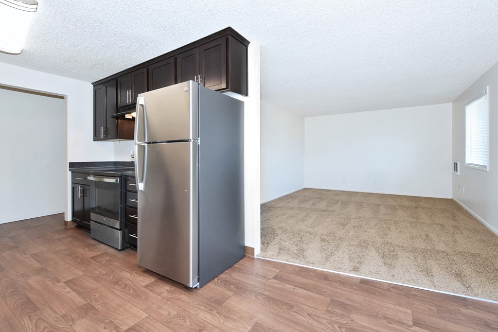 a kitchen and an empty living room in a micro apartment