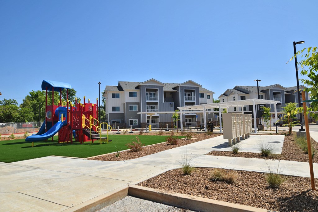 an image of the playground at the whispering winds apartments in pearland, tx