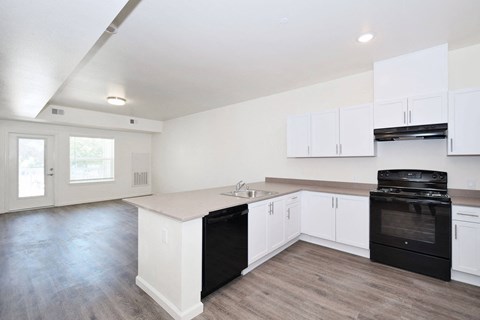 the preserve at ballantyne commons apartment kitchen and living room with white cabinets