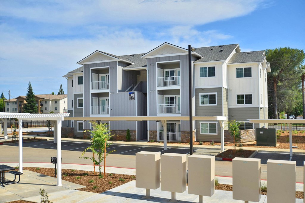 a large apartment building with a parking lot in front of it