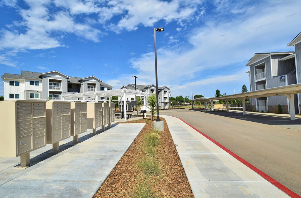 a row of houses with mailboxes on the side of the road